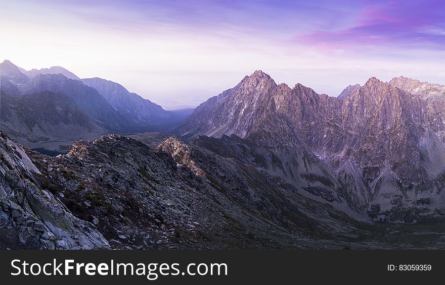 Brown Black and White Mountain Under White and Blue Cloudy Sky