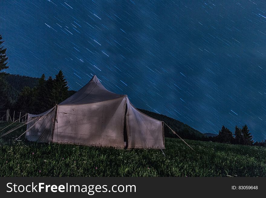 Brown Tent on Green Grass during Night Time