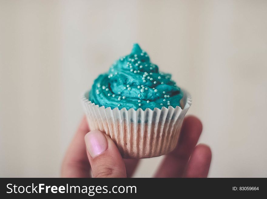 Cupcake With Teal Icing and Sprinkles