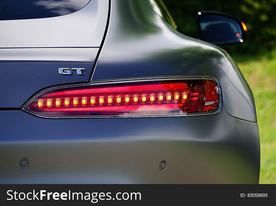 Close up on taillight and rear of blue sports car on sunny day. Close up on taillight and rear of blue sports car on sunny day.