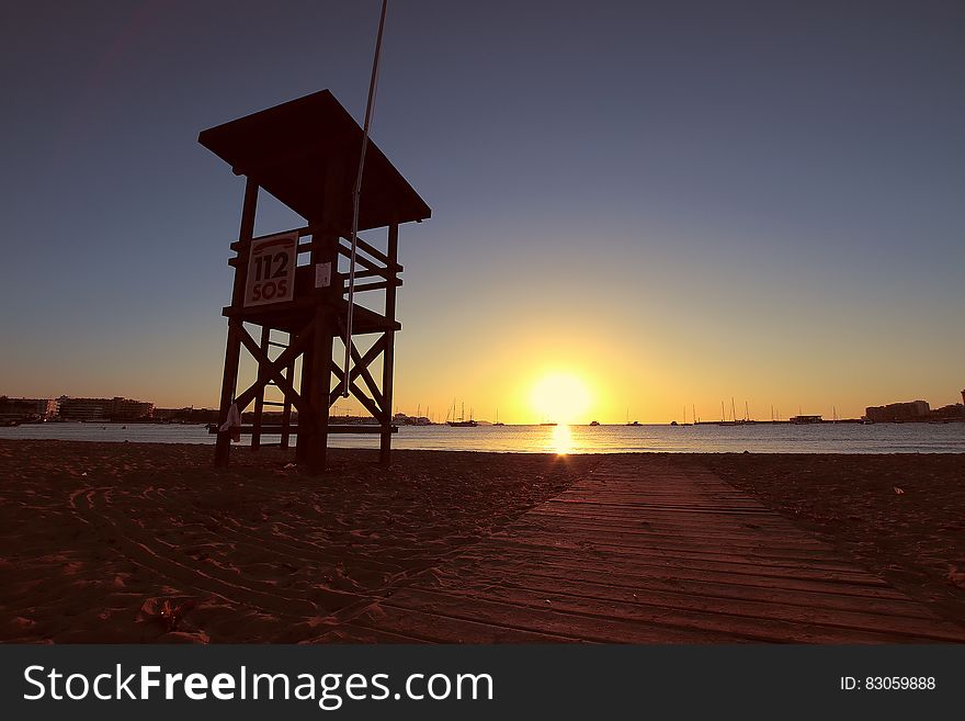 Lifeguard chair on beach at dawn