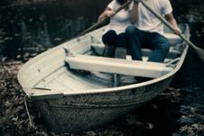 Free Man And Woman Sitting On Boat Holding Paddles Royalty Free Stock Photography - 83060437