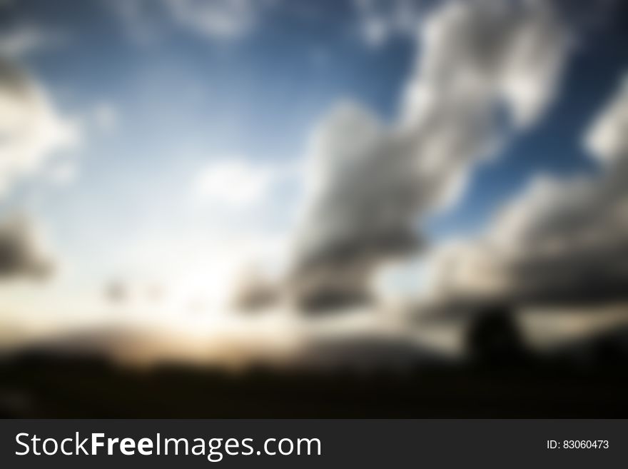 Abstract blurry background with white clouds in blue sky. Abstract blurry background with white clouds in blue sky.