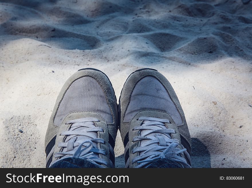 Grey Shoes on Top of Grey Sand