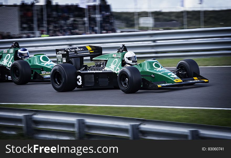 Race cars on track of Formula 1 motor speedway in competition. Race cars on track of Formula 1 motor speedway in competition.