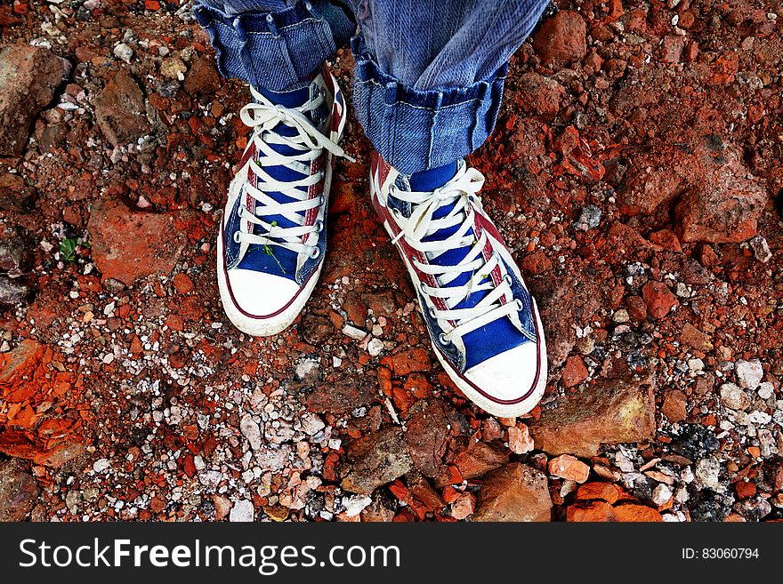 Person In Blue Denim Jeans In Blue And White Sneakers
