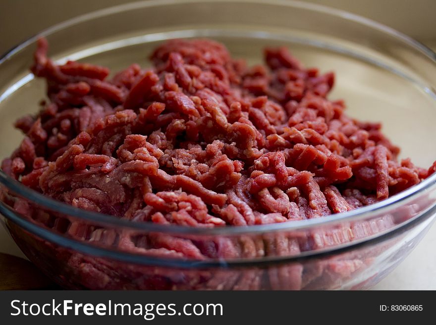 Close up of ground beef in glass bowl. Close up of ground beef in glass bowl.