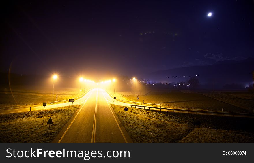 Illuminated roadway with ramps empty at night. Illuminated roadway with ramps empty at night.