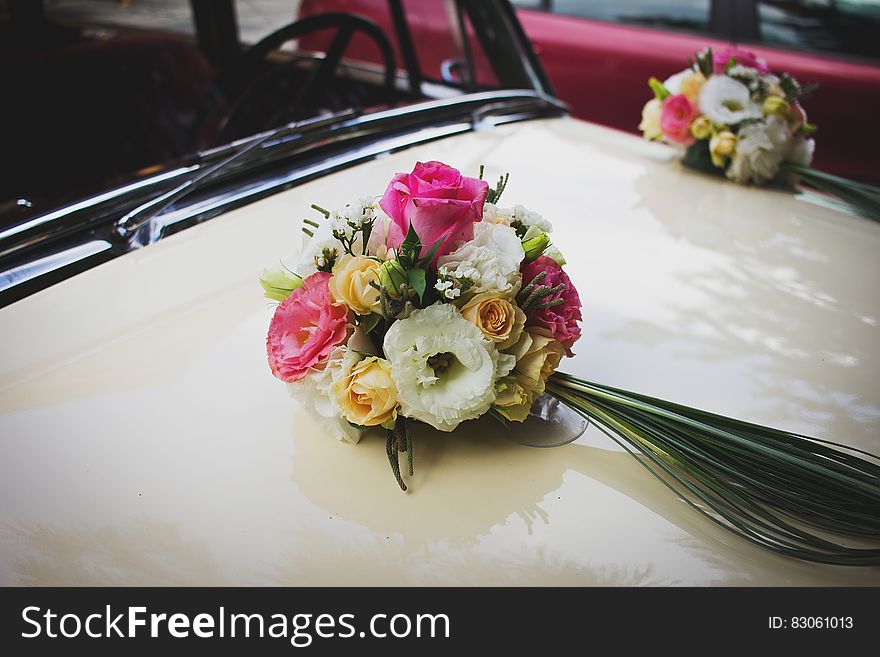 Pink Green and White Flower Bouquet on Beige Car