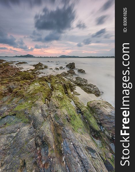 A view over a rocky coast at dusk.