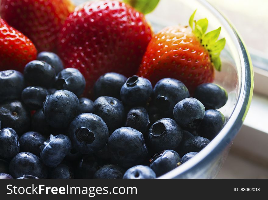 Black Berries Served Beside Strawberry On Clear Glass Bowl