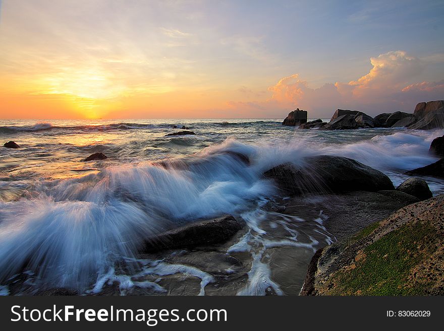 Waves on rocky shores at sunrise