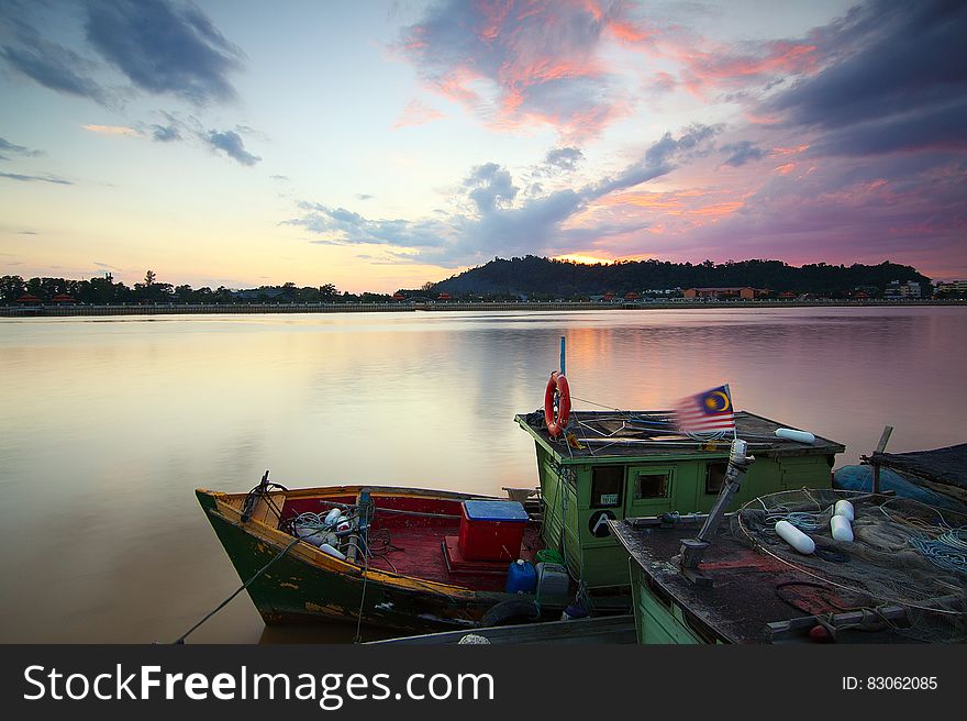 A boat on a river at sunset. A boat on a river at sunset.