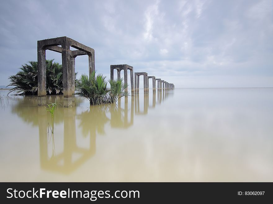 A flooded landscape with concrete structures rising from the water.