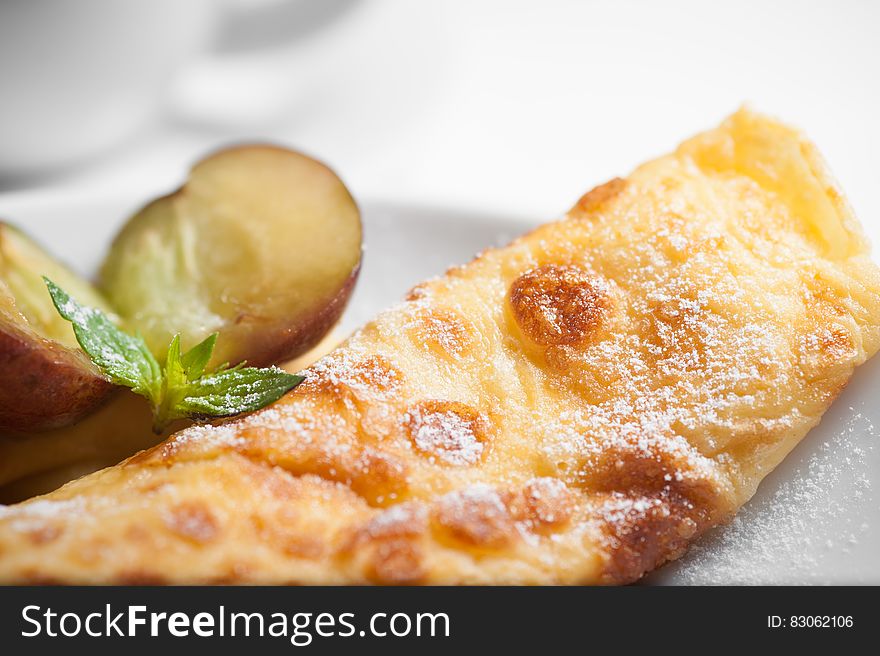 A fried bread with fruits on plate.