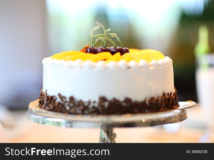 White Round Cake Topped With Yellow Slice Fruit