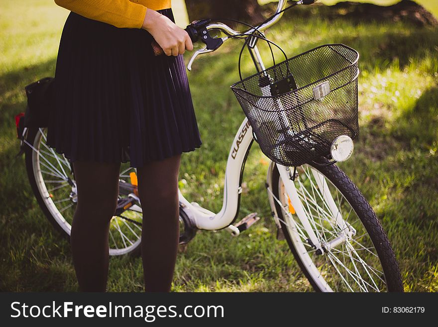 Woman supporting a new white bicycle