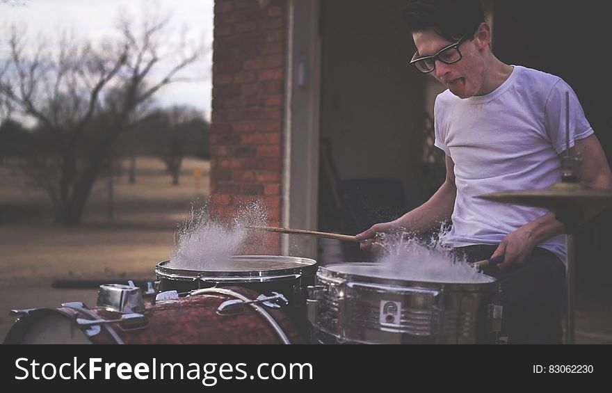 Person Playing On Drums During Daytime