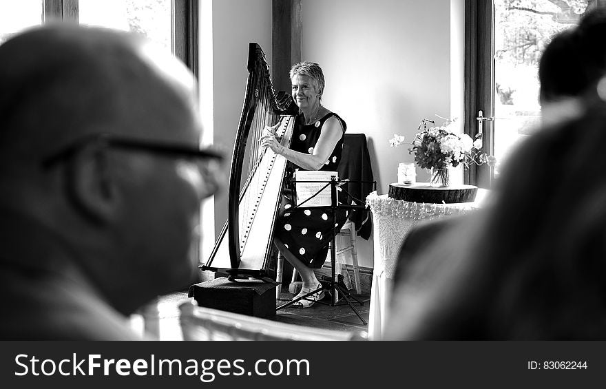 Woman Playing Harp on Stage Grayscale