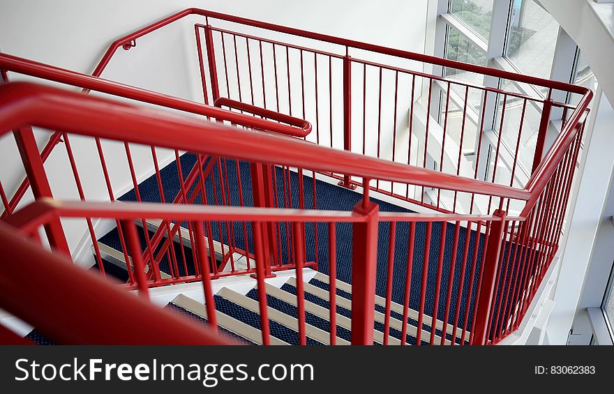 Blue and White Wooden Stairs With Red Metal Handrails