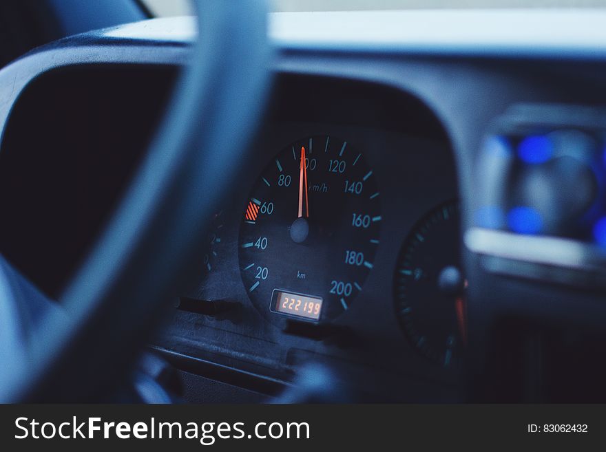 Close up of speedometer and steering wheel inside car. Close up of speedometer and steering wheel inside car.