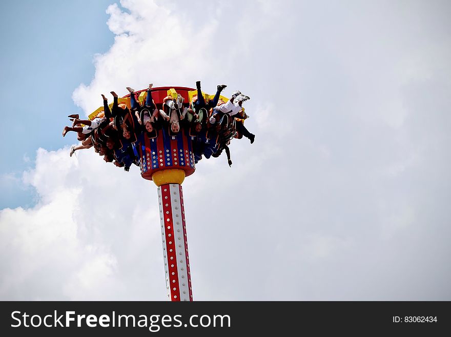 People Riding on White and Red Carnival Rides