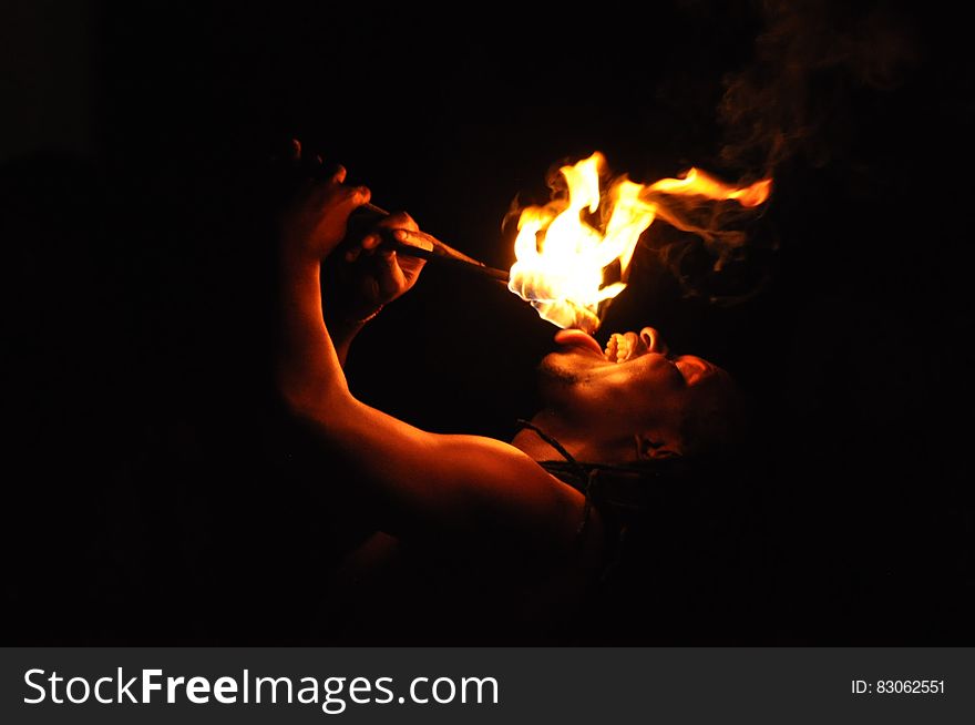 Portrait of male fire eater performer at night. Portrait of male fire eater performer at night.