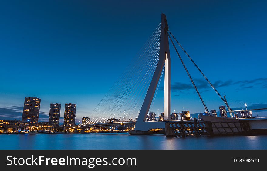 Suspension Bridge Over River At Twilight