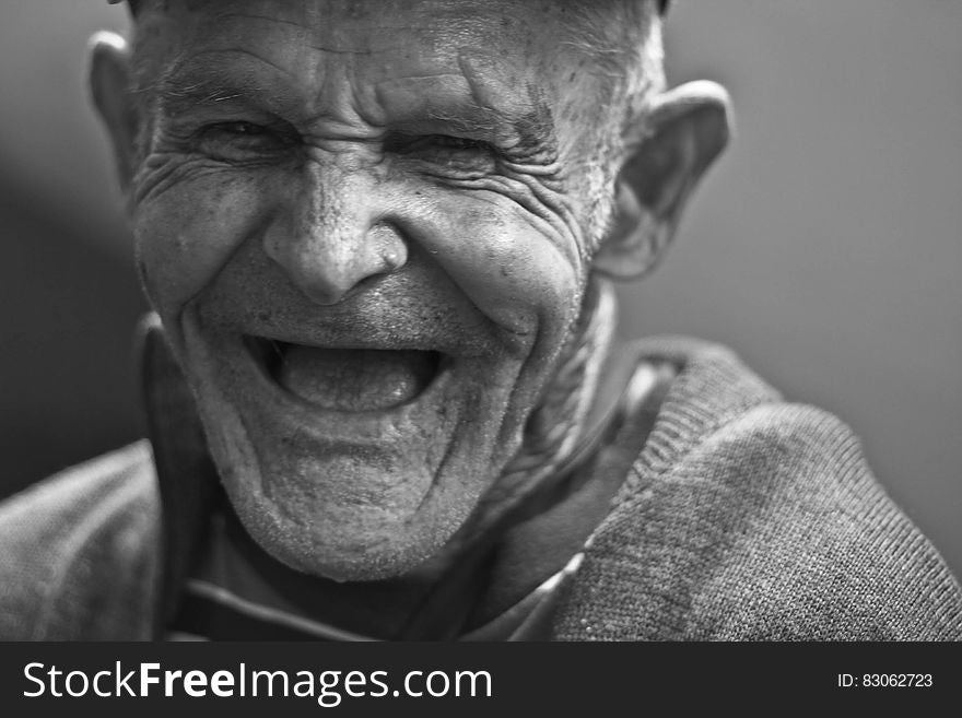 Grayscale Photo of Laughing Old Man