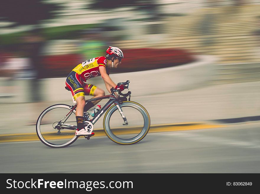 Blur of pan with man riding bike in race on roadway. Blur of pan with man riding bike in race on roadway.