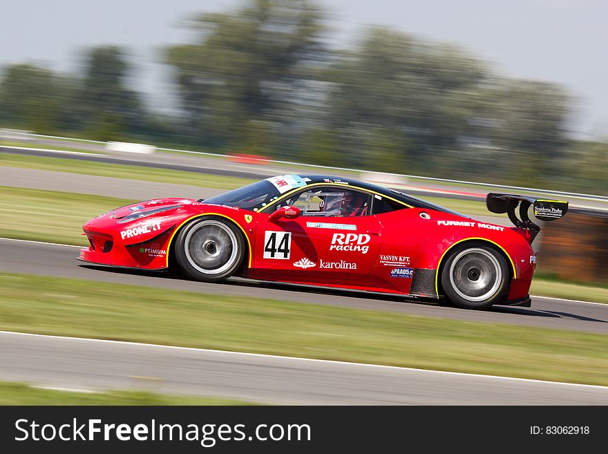 Red Racing Car on Race Track during Daytime