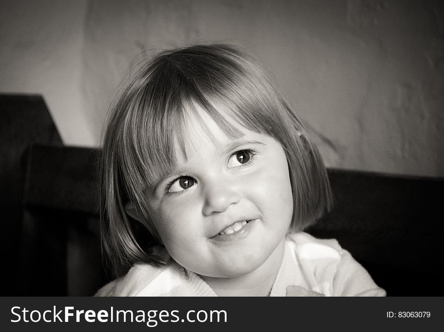 Portrait Of Smiling Girl With Short Hair In Grayscale Photography