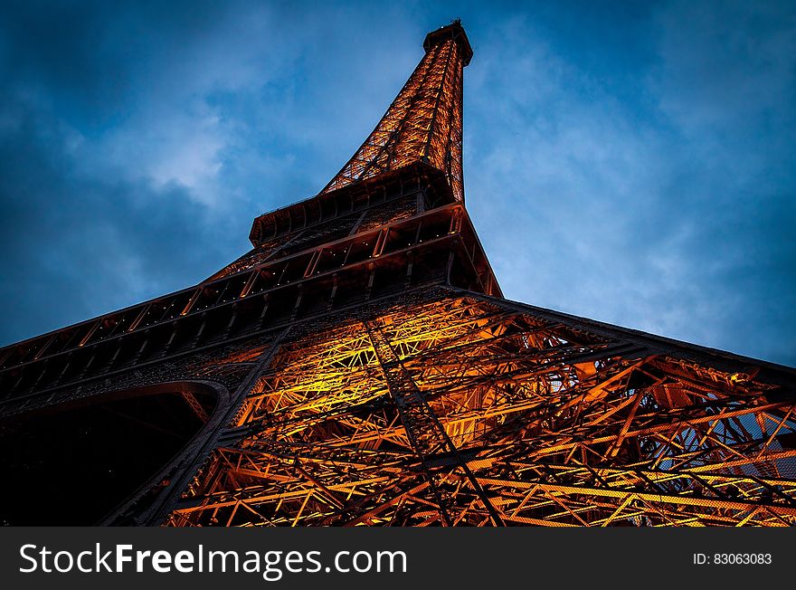 Eiffel Tower Under Cloudy Sky During Nighttime