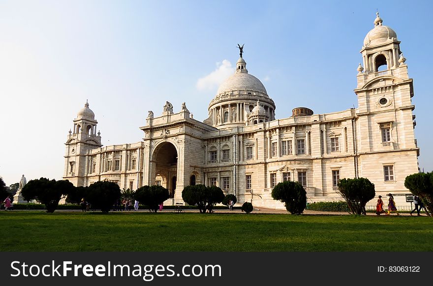 Palace exterior with green lawn on sunny day against blue skies. Palace exterior with green lawn on sunny day against blue skies.