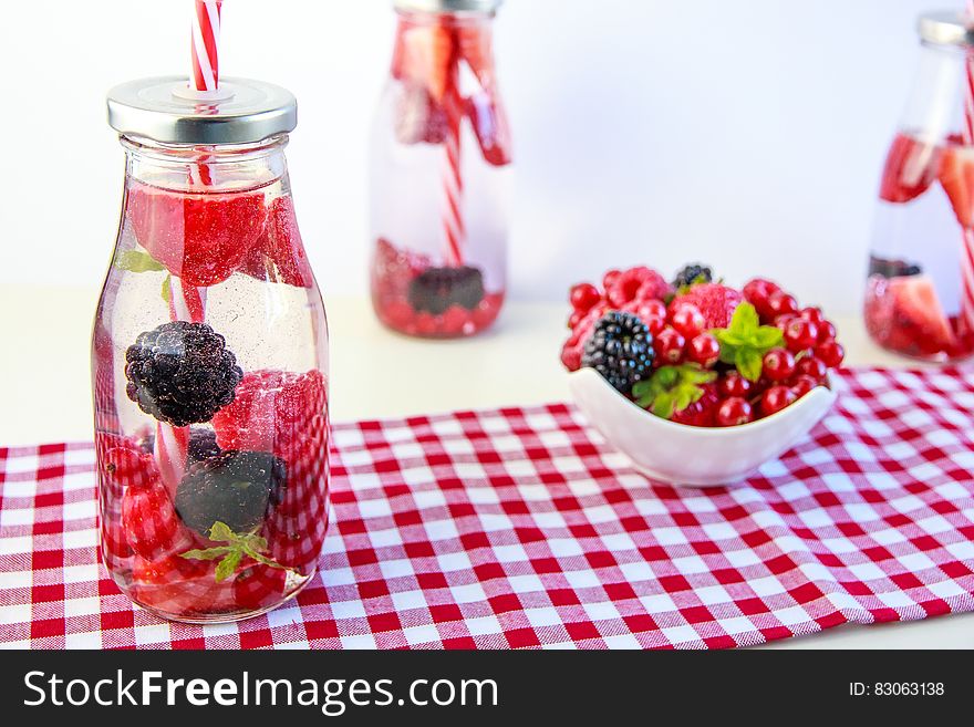 Red Cherry And Grapes On Clear Glass Bottle