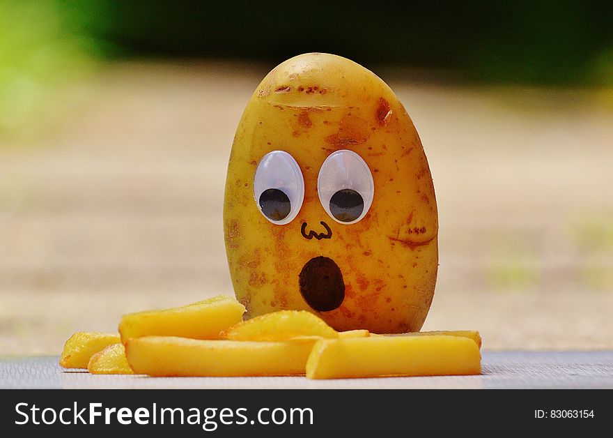 Brown Potato In Front Of French Fries