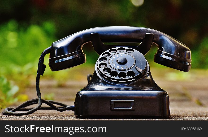 Selective Focus Photography of Black Rotary Phone