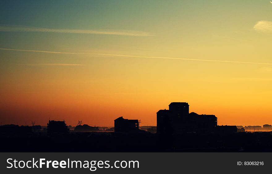 Silhouette of High Rise Building Under Golden Sun