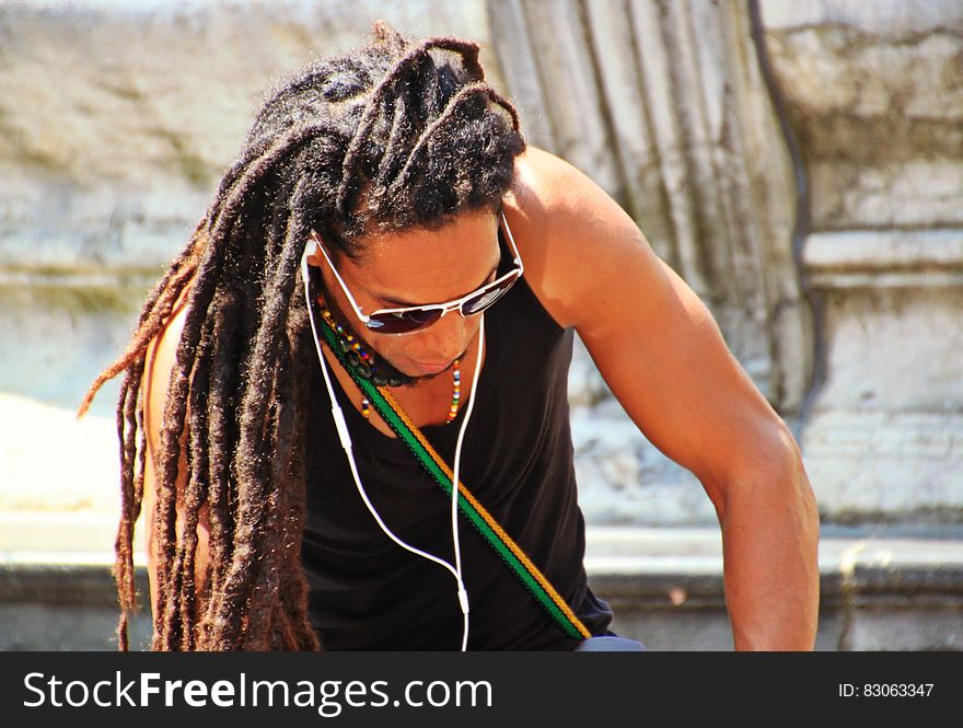 Man in Black Tank Top With Braided Hair
