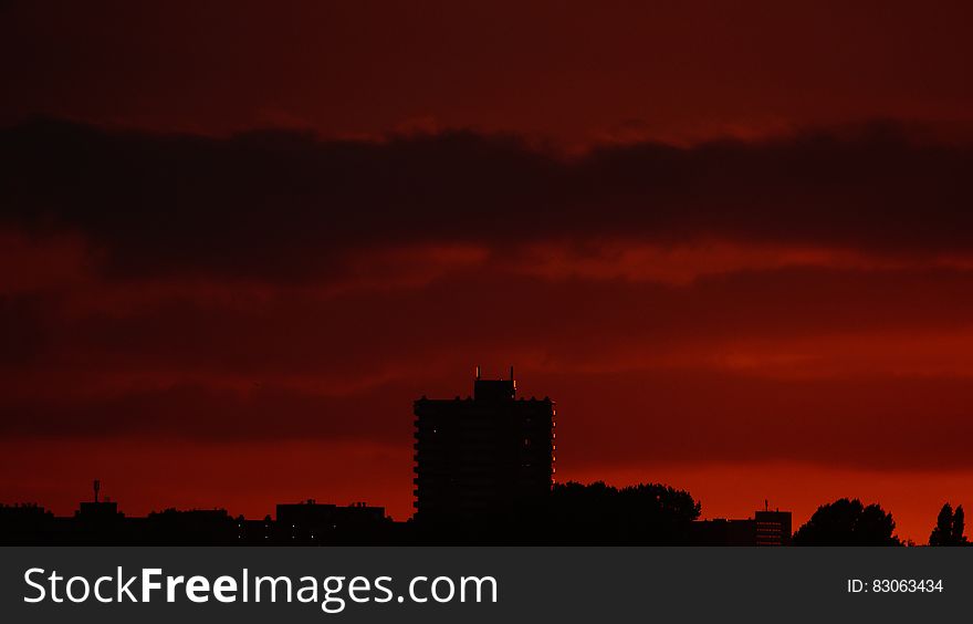 Silhouette of Building Structures Against Red Skies