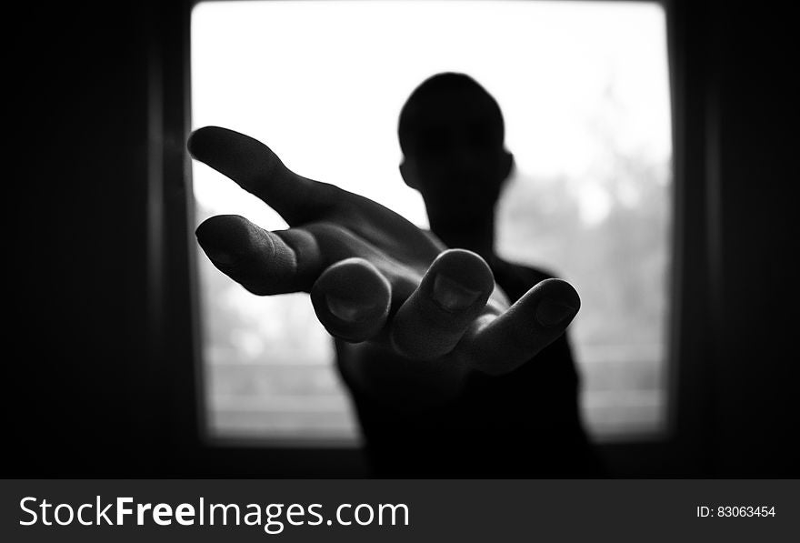 Man&#x27;s Hand in Shallow Focus and Grayscale Photography