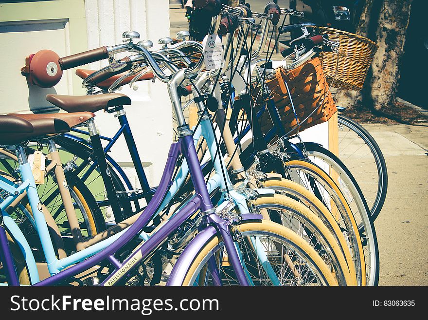 Row of bicycles on streets on sunny day.