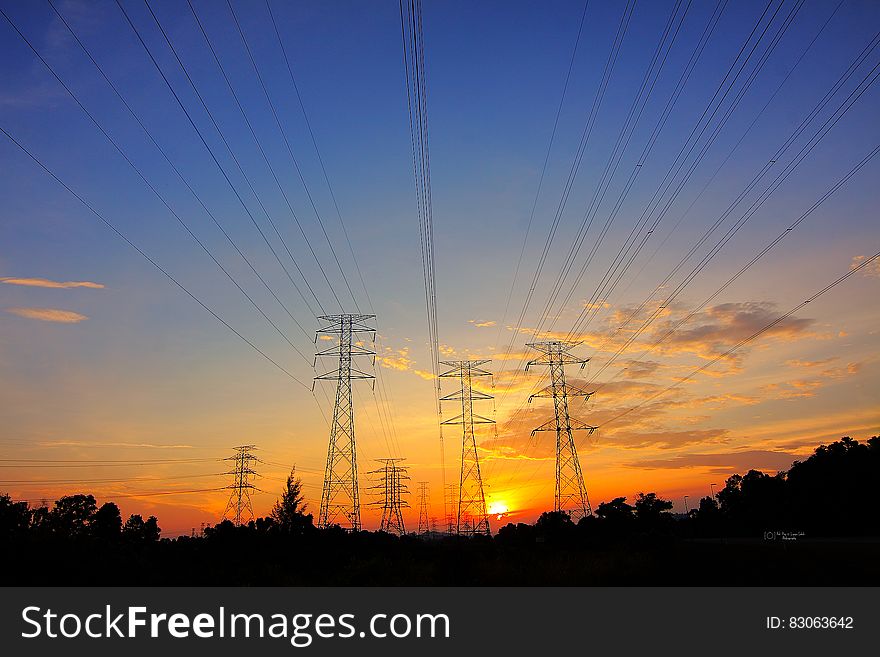 Power lines and transformers in rural countryside at sunset. Power lines and transformers in rural countryside at sunset.