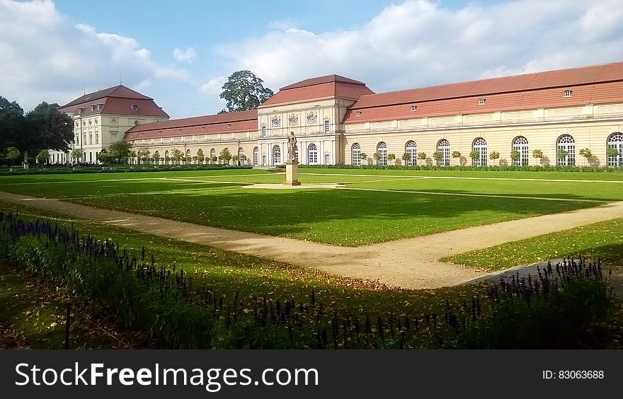 Exterior of Charlottenburg Castle, Berlin, Germany with green lawns on sunny day.