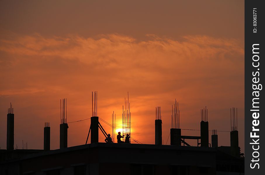 Silhouette of Men in Construction Site during Sunset