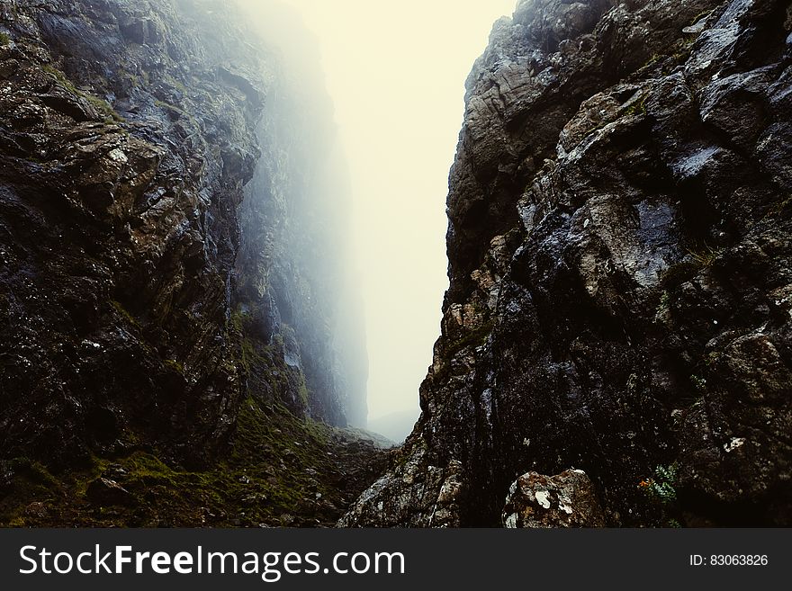 Misty gap between rocky cliffs in Scotland.