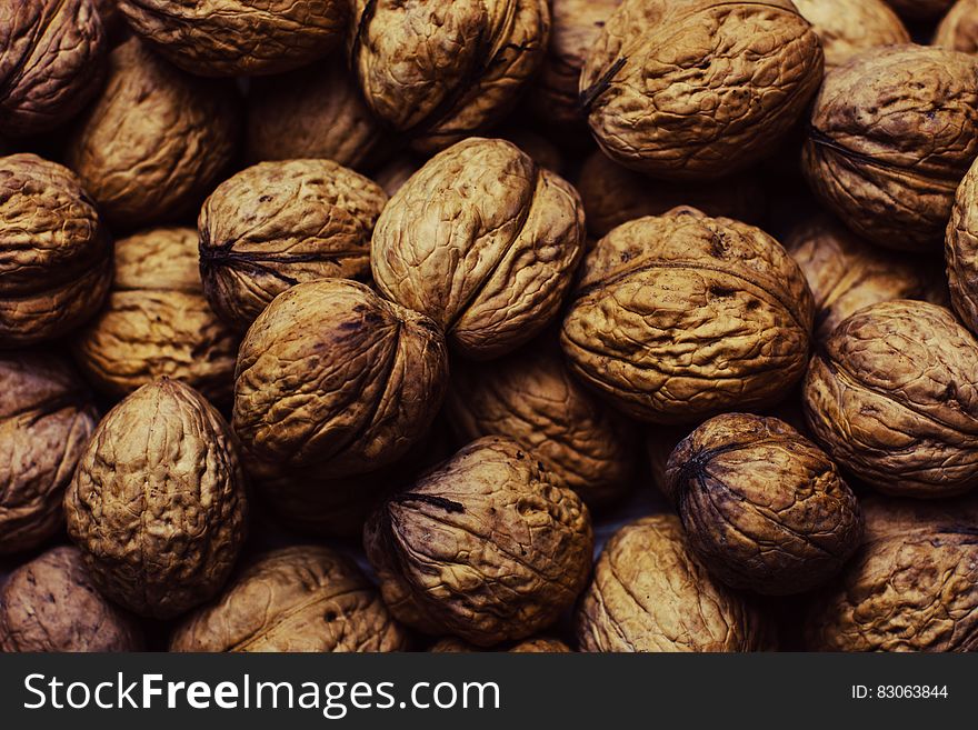 Close up of whole walnuts in the shell.