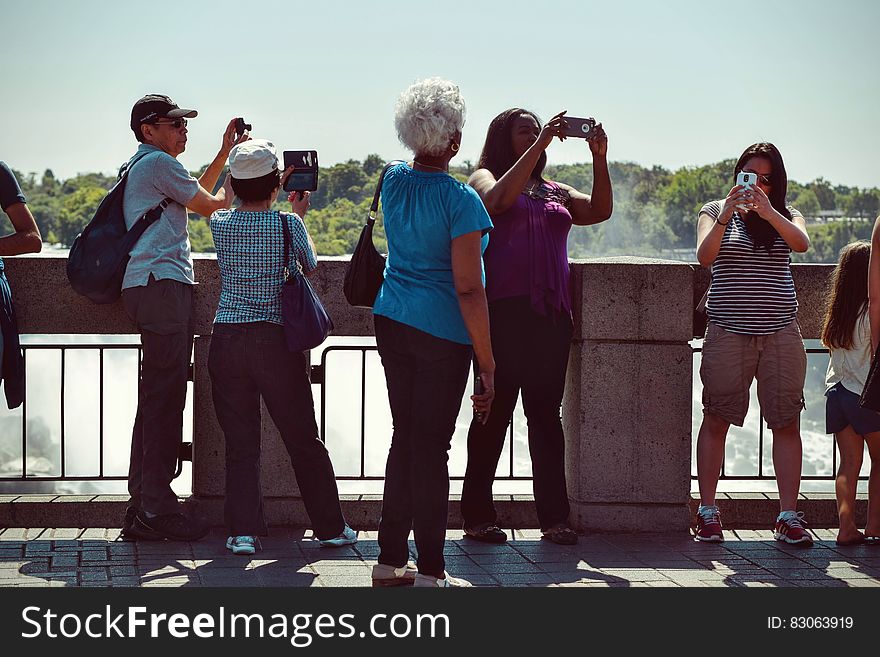 People Taking Pictures during Daytime