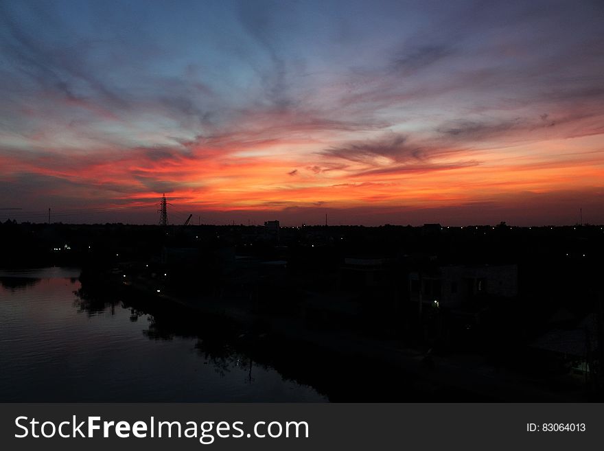 Silhouette Photo Of Skyline Building Below Orange And Blue Sky