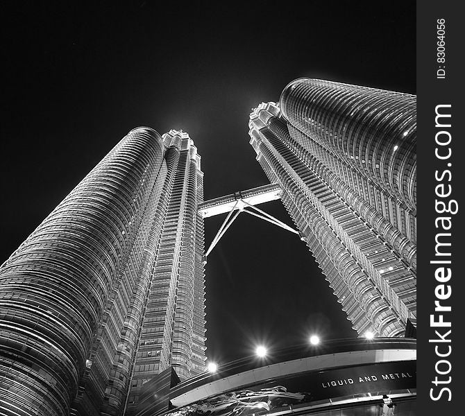 Facade of Petronas Twin Towers in Kuala Lumpur, Malaysia illuminated at night in black and white. Facade of Petronas Twin Towers in Kuala Lumpur, Malaysia illuminated at night in black and white.